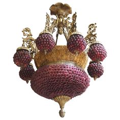 a chandelier with grapes hanging from it's sides