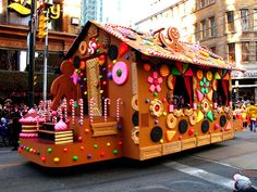 a float is decorated with candy and candies on the street in front of people