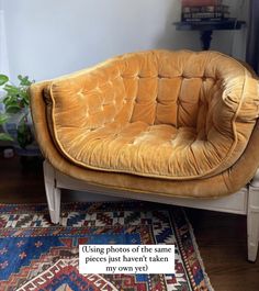 a couch sitting on top of a wooden floor next to a rug