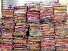 a large pile of colorful fabrics sitting on top of each other