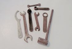 several wrenches and spanners on a white surface with space for the wording