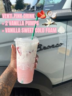 a person holding up a pink drink in front of a truck with the words ventt pink drink vanilla pumps vanilla sweet cold foam