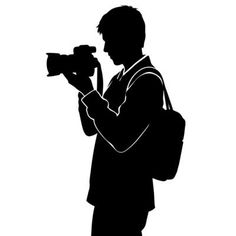 a man with a camera silhouetted against a white background