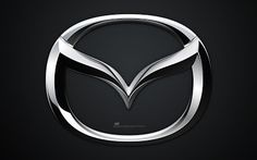 the mazda logo is shown on a black background in this image, it appears to be an emblem