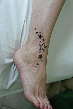 a person has a small star tattoo on their foot