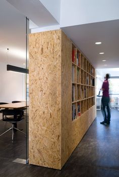 an image of a person standing in front of a book shelf that is made out of plywood