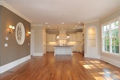 an empty living room with hard wood floors