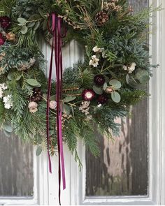 a christmas wreath hanging on the front door