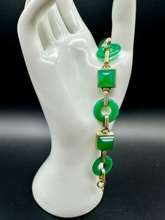 "Fabulous Rare 1930s Art Deco 14k Gold Chrysoprase Lifesaver Sugarloaf Bracelet  Sugarloaf Cabachons connect to lifesaver chrysoprase gems via 14k gold links. Our tester indicated 18k but we are pricing per the consignment client at 14k. All stones in very nice condition. Slight wear scratches from age. Spring ring close works well.  Measures 7 1/2\" Truly wonderful vintage piece to add to your jewelry collection. Weight: 24.1g Ref # CF" Yellow Gold Art Deco Bracelet, Art Deco Jade Jewelry For Formal Occasions, Formal Art Deco Jade Jewelry, Art Deco Green Bracelet For Formal Occasions, Luxury Green Rectangular Bracelets, Art Deco Green Bracelets For Formal Occasions, Green Art Deco Bracelets For Formal Occasions, Formal Gold Chrysoprase Jewelry, Retro Green Bracelet Jewelry