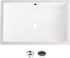 a white square sink with two faucets on the side and one drain in the middle