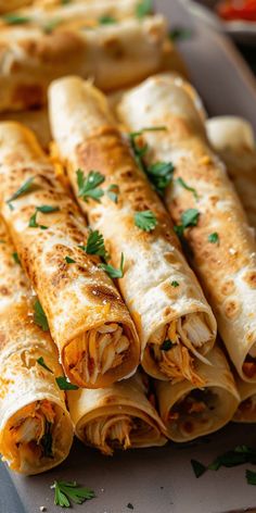 several burritos on a plate with some garnish