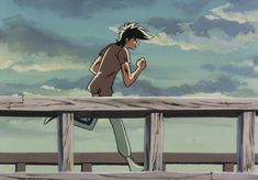 a woman running across a wooden bridge over looking the ocean with clouds in the background