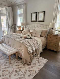 a large bed sitting in a bedroom on top of a wooden floor next to a window