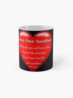 a black and white mug with a red heart on it that says, love one another