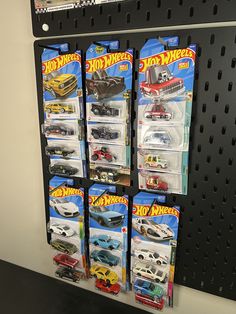 several hot wheels toys are on display in a store shelf next to other toy cars