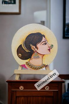 a decorative plate with a woman's face painted on it