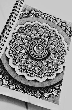 a spiral notebook with an intricate design on it