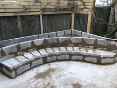 an outdoor bench made out of cinder blocks