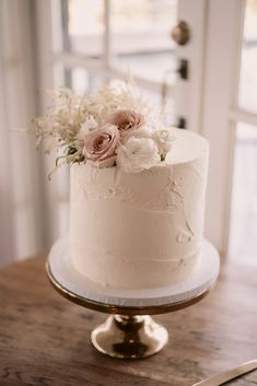 a white cake sitting on top of a wooden table