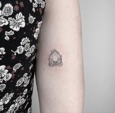 a woman with a small tattoo on her arm