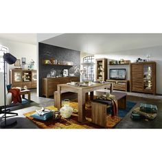 a living room filled with furniture and a flat screen tv on top of a wooden table