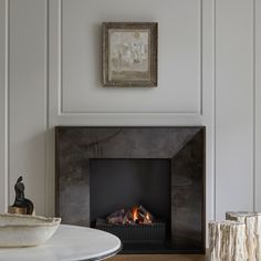 a fire place in a living room next to a table