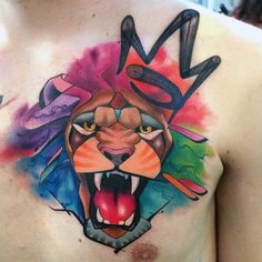 a man's chest with a colorful tattoo on his chest and an image of a lion