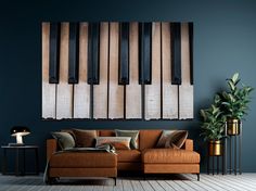 a living room with a couch, table and piano keys on the wall above it