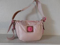 "Beautiful soft pink shoulder bag Shoulder-friendly wide straps with ram leather trim Ram leather trims Hot pink lining Front has a big pocket with hot pink clamp closure supported by leather Inside zipper closure, a small pocket and a large pocket Born in the glamorous USA Adjustable strap Normal wear signs but condition is great - see photos for quality Dimension - length 15\" height 11\" depth 6.5\" strap drop 21\" strap width 2 1/4\"" Pink Canvas Shoulder Bag With Handles, Pink Shoulder Bag With Adjustable Handle, Pink Shoulder Bag With Hasp Closure, Pink Tote Shoulder Bag With Zipper Pocket, Pink Shoulder Bag With Zipper For On-the-go, Juicy Couture Baby, Yellow Tote Bag, Pink Shoulder Bag, Cowboy Belt