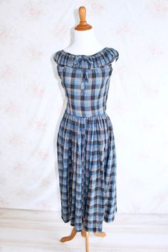 ♥ 1940s Plaid Sundress ♥ It features: * Blue, black, and white plaid pattern * A line shape * Bow on neckline * Midi length * Sleeveless * A mix of hook and snap closures underneath arm * No tag   Condition: Good Measurements: Bust: 15.5 inches (double this measurement for full circumference) Waist: 12 inches (double this measurement for full circumference) Hips: 24 inches (double this measurement for full circumference) Length 44.5 inches Please take into consideration vintage garments might sh Blue Day Dress, Blue Day, Vintage 40s, 1940s Dresses, Black And White Plaid, Summer Blue, Day Dress, Plaid Dress, White Plaid