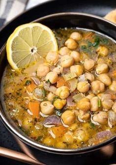 a bowl filled with soup and garnished with lemon