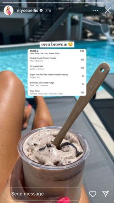 someone is holding a cup of ice cream in front of a swimming pool with an instagram message