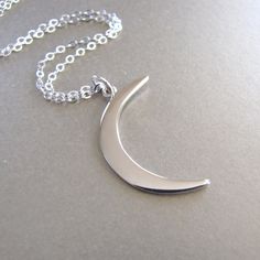 "Polished sterling silver crescent moon pendant necklace. Pendant (mm): 31 x 10 x 1 Chain: sterling silver flat cable chain available in 16\" and 18\" Also available in gold: https://www.etsy.com/listing/157765641/gold-crescent-moon-necklace Let's keep in touch, sign up for our newsletter and receive 15% off your first order https://lp.constantcontact.com/su/Dpyaymg" Modern Crescent Moon Charm Jewelry, Modern Silver Moon Jewelry, Modern Sterling Silver Moon Jewelry, Modern Sterling Silver Moon-shaped Jewelry, Modern Silver Moon-shaped Jewelry, Modern Silver Half Moon Jewelry, Modern Silver Half-moon Jewelry, Modern Half Moon Silver Jewelry, Crescent Moon Necklace Silver