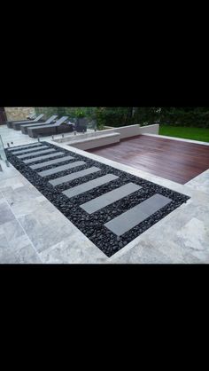 an outdoor patio with stone steps and wood decking