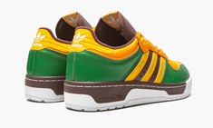 Green/burgundy/yellow leather-blend x Human Made Rivalry sneakers from adidas featuring colour-block panelled design, signature three-stripe logo, branded heel counter, round toe, front lace-up fastening and flat rubber sole.  POSITIVELY CONSCIOUS: adidas Group scores 4 out 5 with independent ethical brand rating agency Good On You.  It uses eco-friendly materials in many products – 100% of its cotton is from sustainable sources and it's committed to use 100% recycled polyester by 2024.  It trac Adidas Retro Skate Shoes With Rubber Sole, Retro Adidas Skate Shoes With Rubber Sole, Adidas Leather Skate Shoes With Logo, Custom Adidas Leather Sneakers For Sports, Custom Adidas Logo Leather Sneakers For Sports, Retro Adidas Low-top Skate Shoes, Yellow Adidas Lace-up Sneakers, Custom Leather Adidas Sneakers For Sports, Sports Sneakers With Rubber Heel Cap