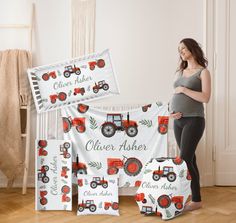 a pregnant woman standing in front of her bed with four personalized farmall themed blankets