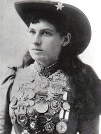 an old black and white photo of a woman wearing a hat with buttons on it