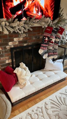 a fireplace with stockings hanging over it