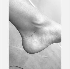 a black and white photo of a person's foot