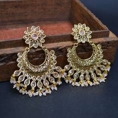 Elevate your elegance with our enchanting Baby Pink Indian Bollywood Earrings Set, a tribute to beauty and tradition. This exquisite ensemble, meticulously handcrafted, features delicate earrings that capture the essence of both Indian aesthetics and contemporary fashion. The soft baby pink hue radiates charm, making it a perfect choice for weddings, engagements, anniversaries, and celebratory gatherings. Each earring is a masterpiece, lovingly crafted from brass and adorned with intricate detai Traditional Bridal Earrings For Reception, Traditional Elegant Bridal Earrings For Reception, Festive Bridal Chandbali Earrings With Elegant Design, Elegant Pearl Earrings With Stone Work For Wedding, Celebration Pearl Earrings With Stone Work, Ornate Stone Work Earrings For Gift, Ornate Stone Work Earrings As Gift, White Bridal Earrings With Intricate Design For Celebration, Elegant Wedding Chandelier Earrings With Stone Work