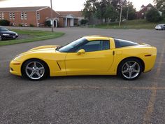 a yellow sports car parked in a parking lot