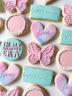 decorated cookies with pink and blue frosting are arranged in the shape of heart shapes