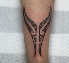 a black and white tattoo on the leg of a person's arm, with two arrows