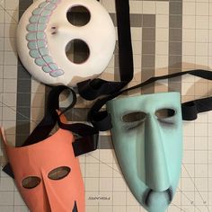 three masks are sitting on top of each other