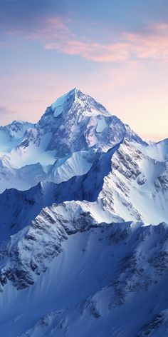 snow covered mountains under a pink sky with clouds in the foreground and below them