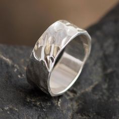 This subtly elegant unisex band ring is the creation of Yan Fredy Bolivia in Peru. The wide ring is crafted of sterling silver with a hammered and polished finish. Minimalist Hammered Wide Band Ring, Gift Wide Band Ring With Hammered Open Design, Modern Wide Band Ring With Hammered Detail, Hammered Wide Band Open Ring As Gift, Elegant Hammered Wide Ring For Promise, Silver Hand Forged Wide Band Open Ring, Hammered Wide Band Ring As Gift, Minimalist Hammered Wide Band Jewelry, Anniversary Hammered Wide Band Ring