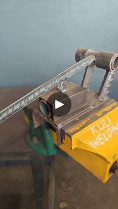 a machine that has some kind of tool on it's handle and is holding something in its hand