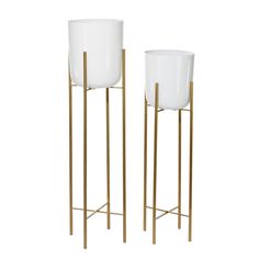 two white glass vases on gold metal stands