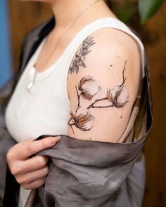 a woman with a flower tattoo on her arm