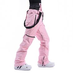 a person wearing pink snow pants and white shoes